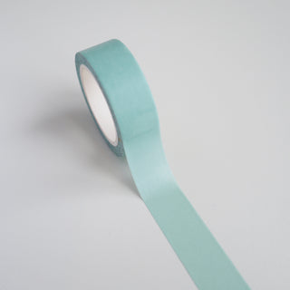 Roll of light blue tape on a gray background