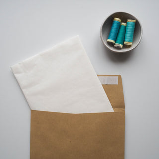 a cut length of patterntrace swedish tracing paper tucked in to a patterntrace sewing pattern storage envelope