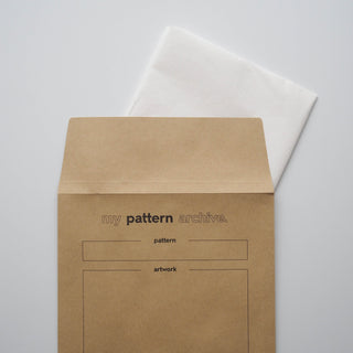 a cut length of patterntrace swedish tracing paper tucked in to a patterntrace sewing pattern storage envelope